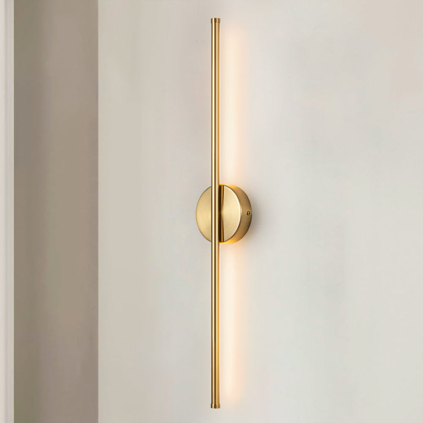 LED cylinder wall sconce highlighting artwork and architectural details