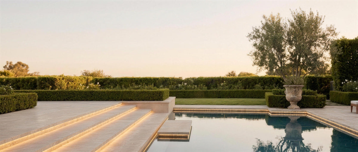 Filo strip lighting glowing under floating travertine pool steps at dusk — lifestyle