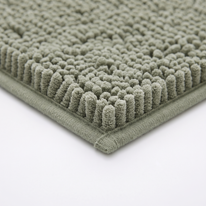 Pebble bath mat bound edge, close-up on white