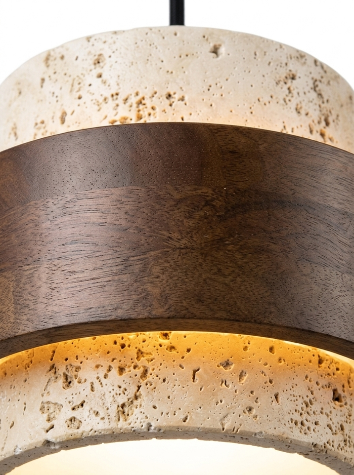 Close-up of the walnut wood band wrapping the travertine shade