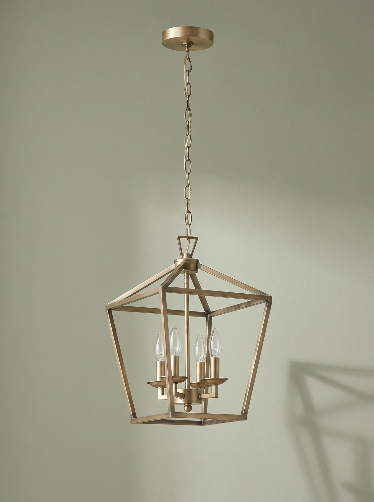 Kiel 4-light lantern pendant in soft gold on a sage backdrop