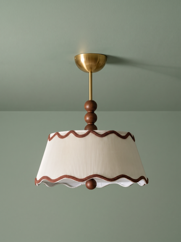 Odette flush mount in cream and walnut on a sage green backdrop