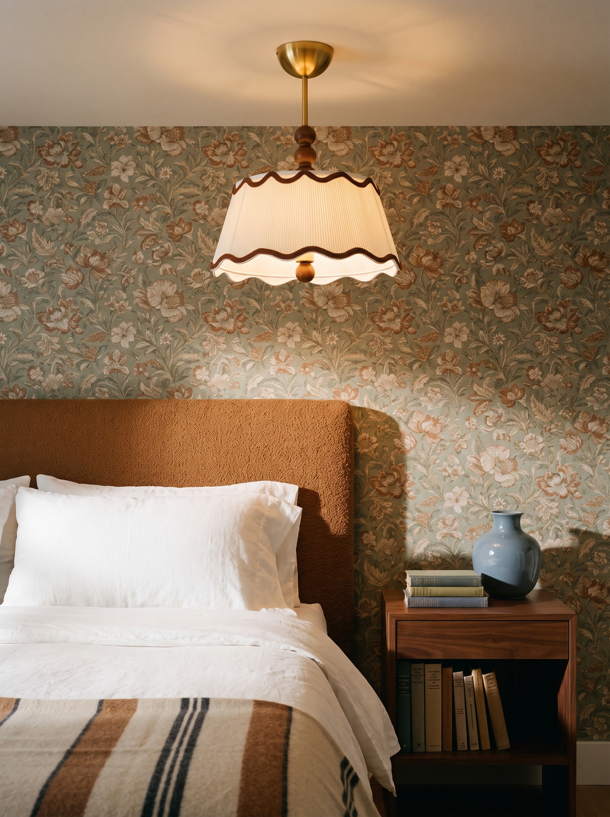 Lifestyle: Odette flush mount above a bed with vintage floral wallpaper