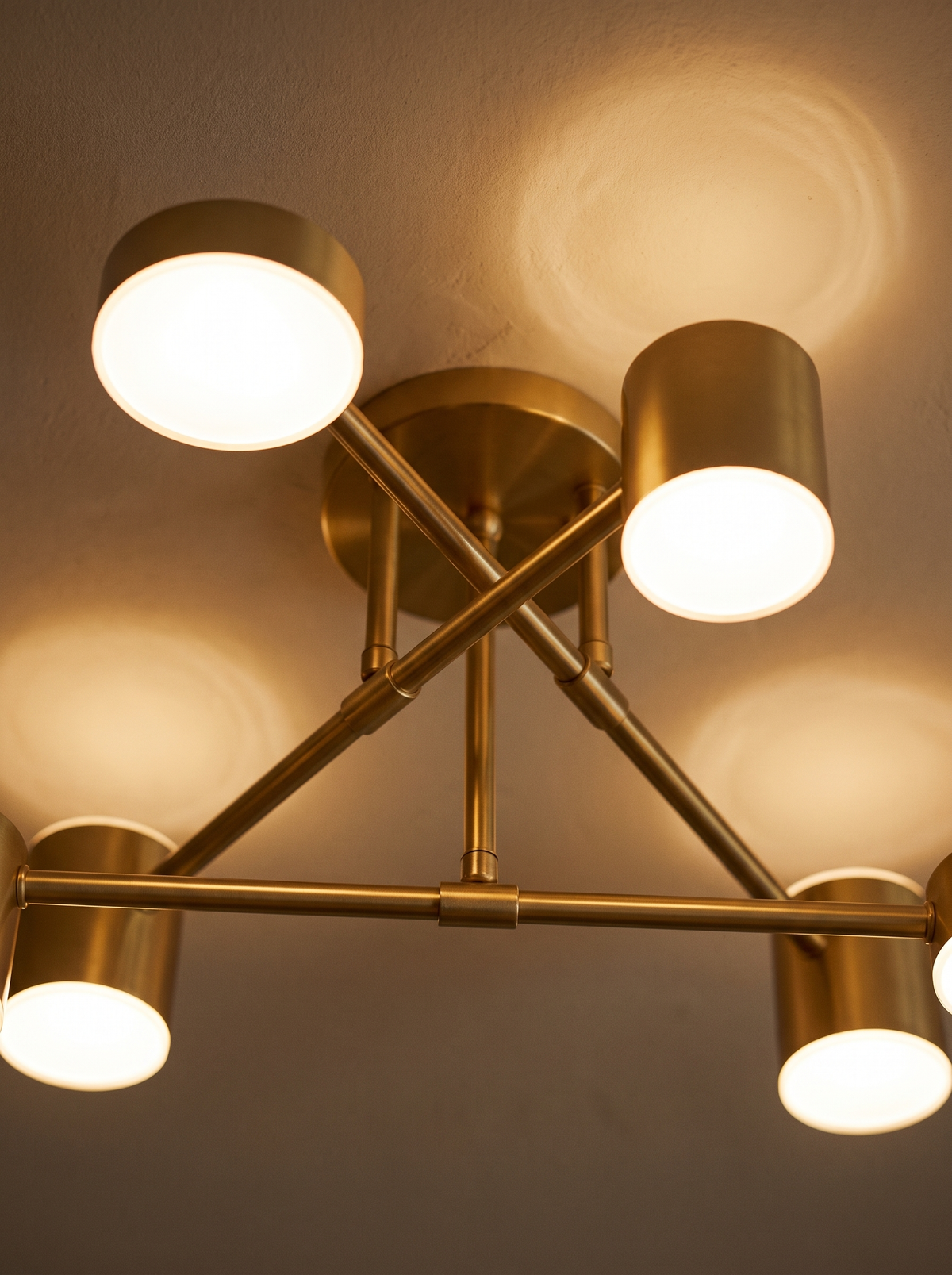 Lifestyle: close-up of Lys's gold arms and glowing acrylic heads