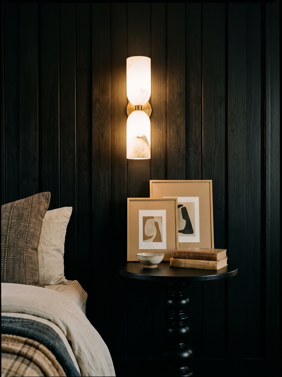 Lifestyle: Nyx alabaster sconce on black board-and-batten panelling in an entry