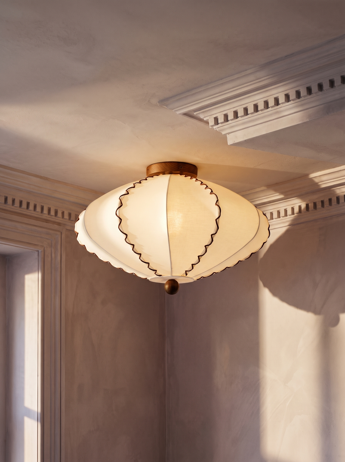 Bonnie scalloped fabric flush-mount ceiling light with walnut finial in a plaster-moulded corner