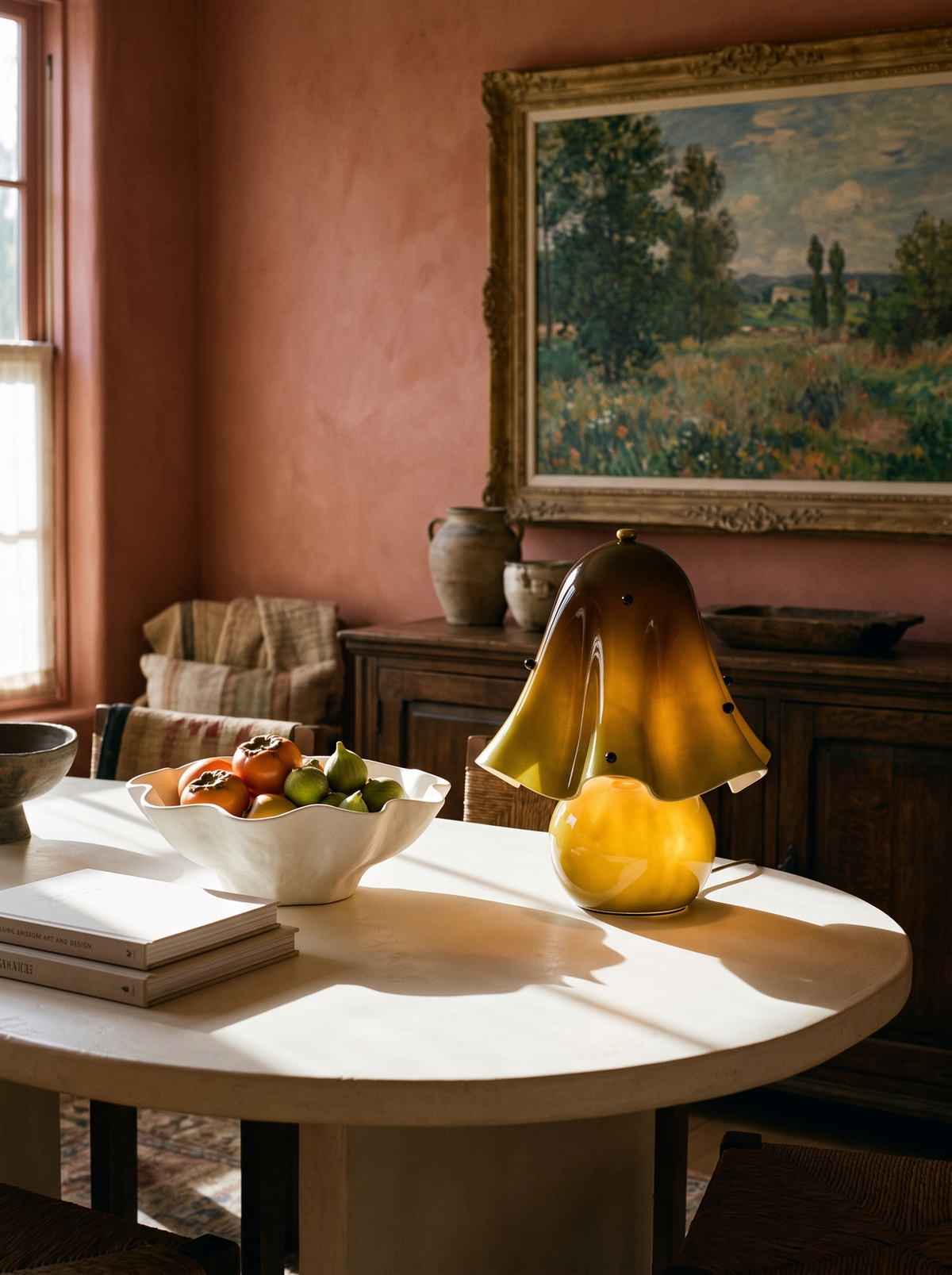 Lifestyle: Petal green glass table lamp on a cream dining table in a terracotta room