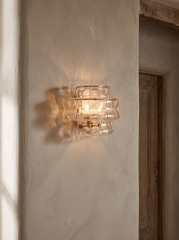 Sylva ribbed-glass wall sconce on a plaster wall