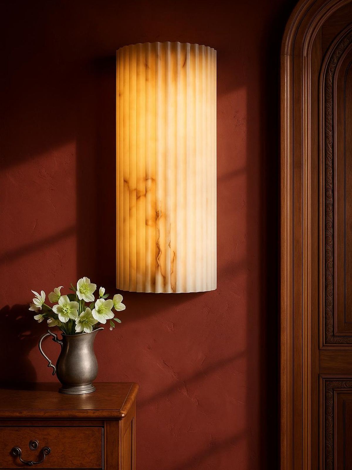Clio large ribbed alabaster wall sconce on an oxblood plaster wall