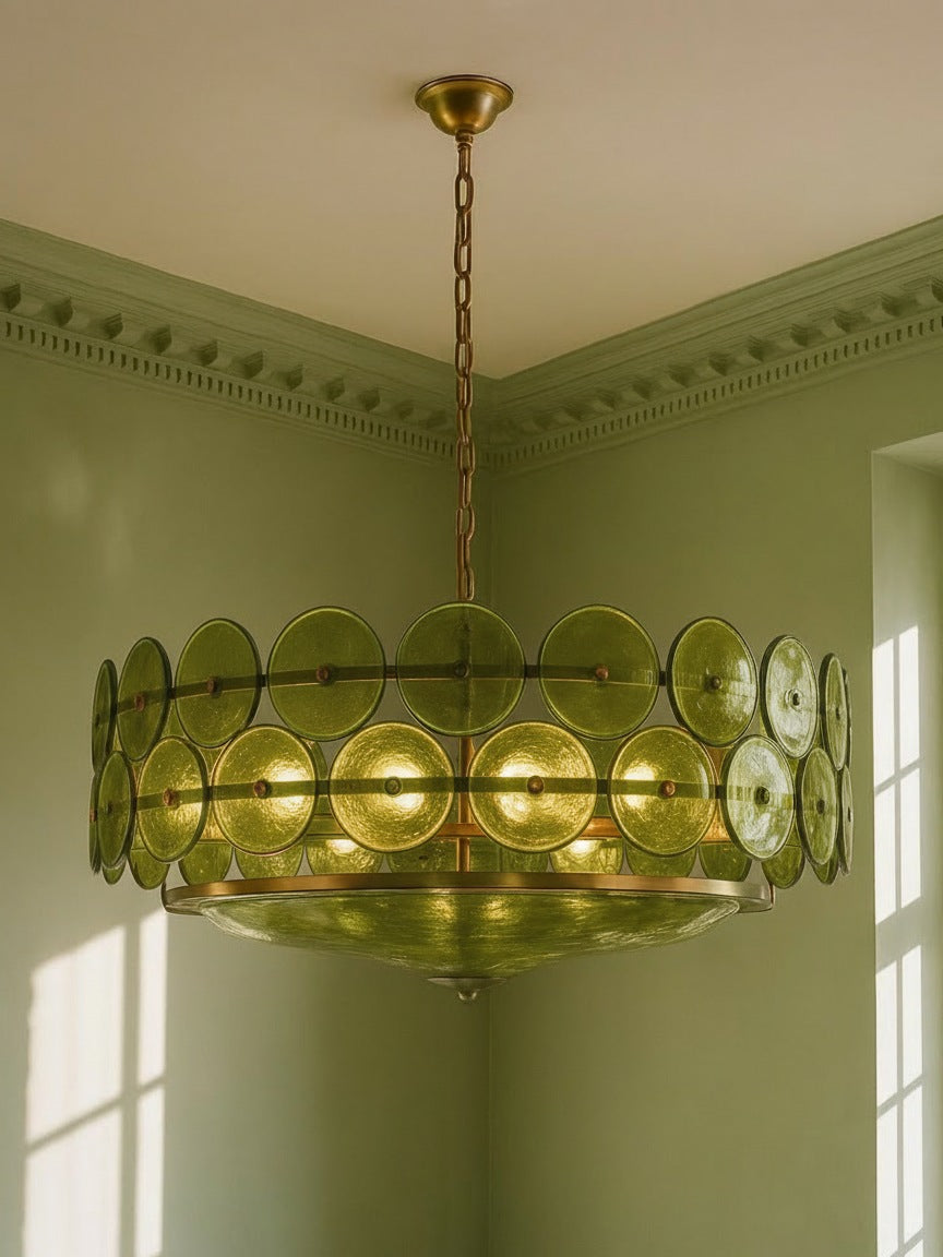 Soleil 31.5-inch olive-green glass disc chandelier hanging in a plaster-moulded corner