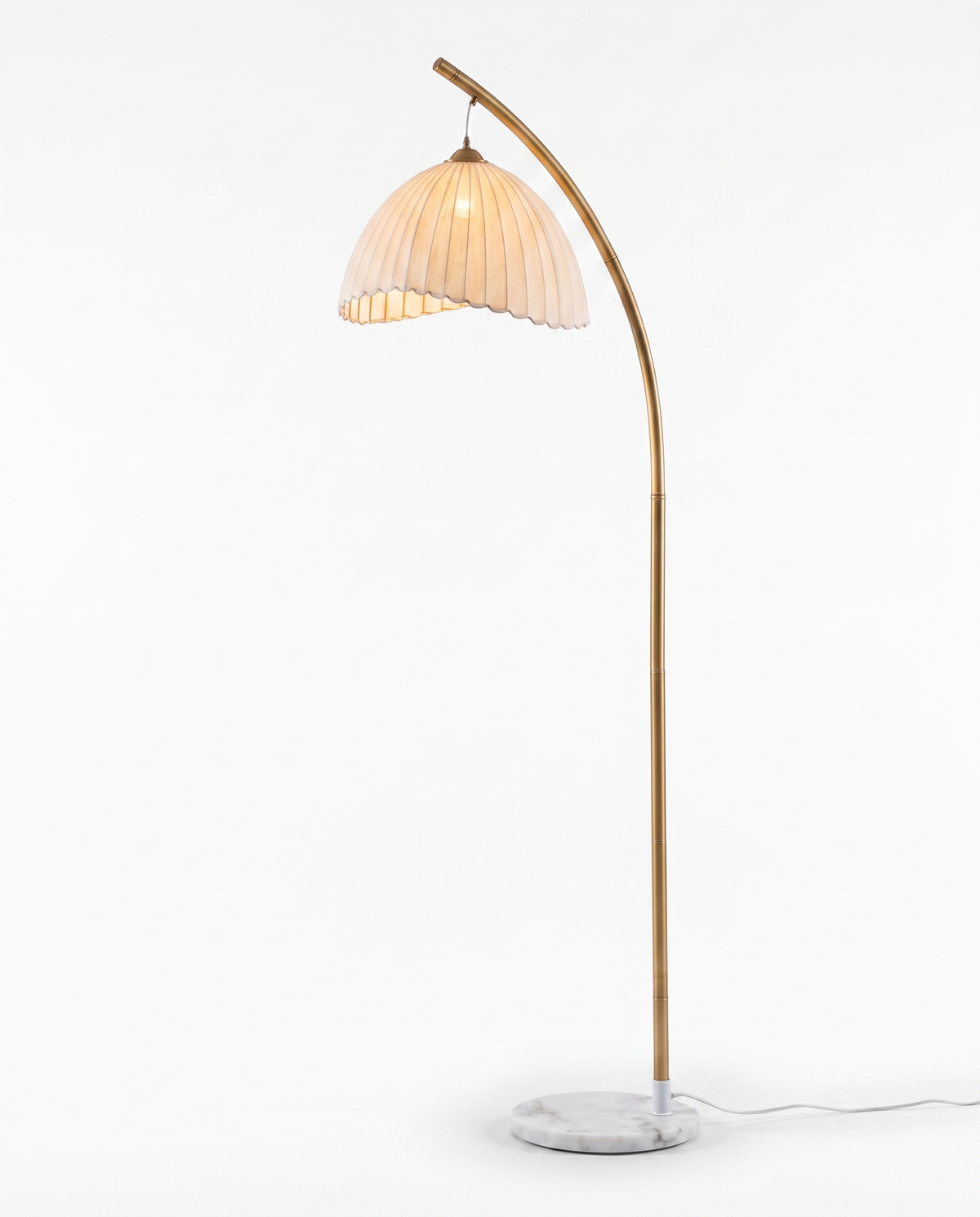 Arcadia warm metallic floor lamp with scalloped shade styled in an elegant living room
