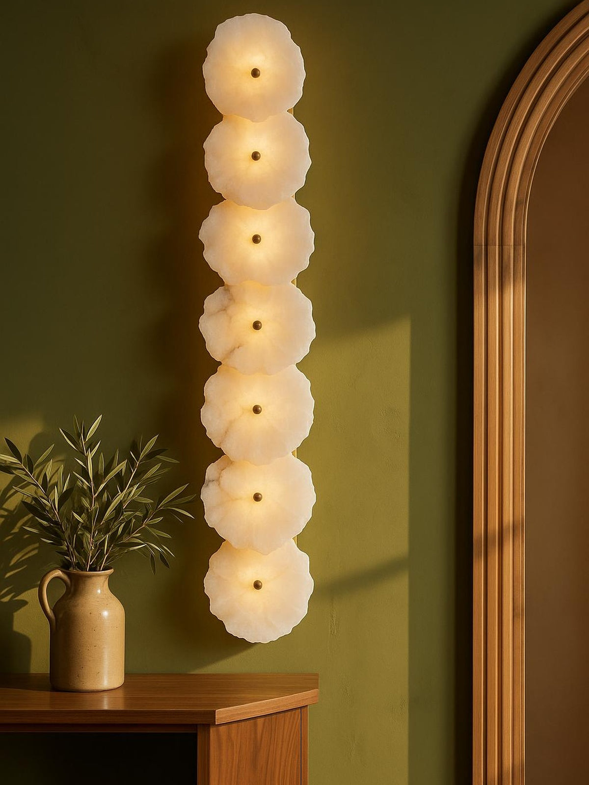 Seren seven-disc alabaster wall sconce on an olive plaster wall