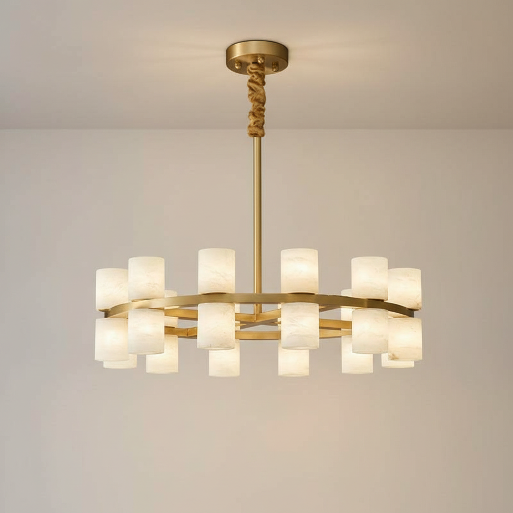 Enzo chandelier glowing warm on a plaster wall