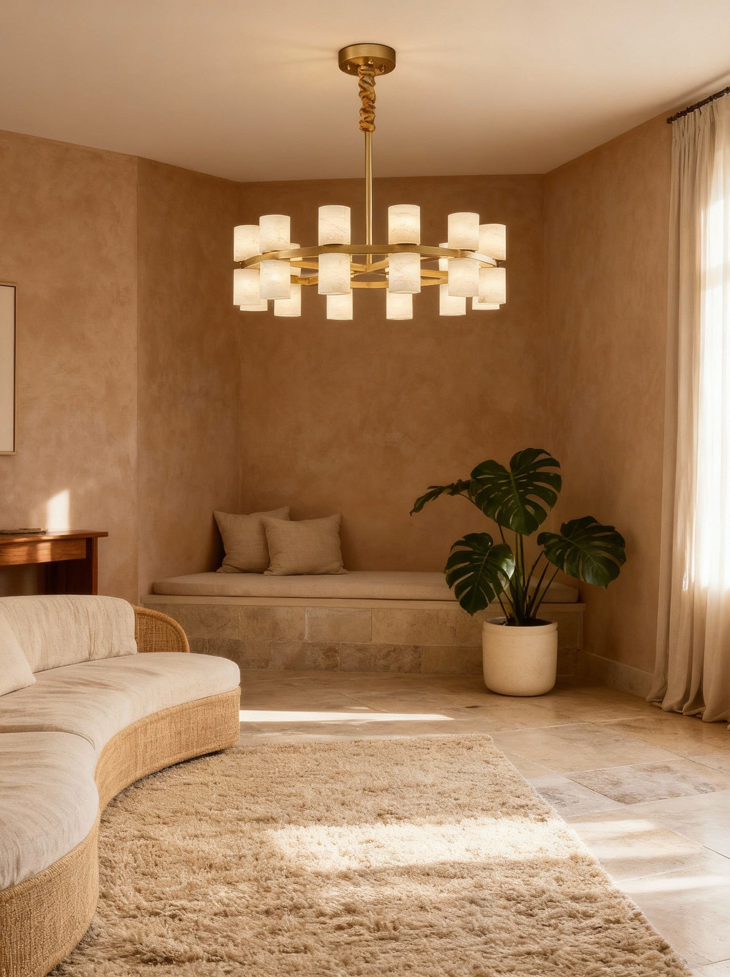 Enzo chandelier above a curved cream sofa, room scene