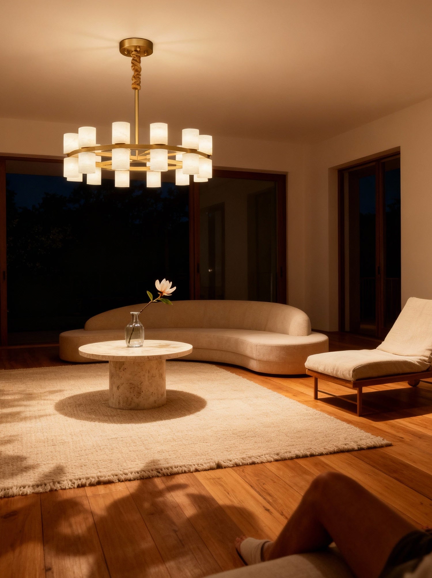 Enzo chandelier lit at dusk in a living room, room scene