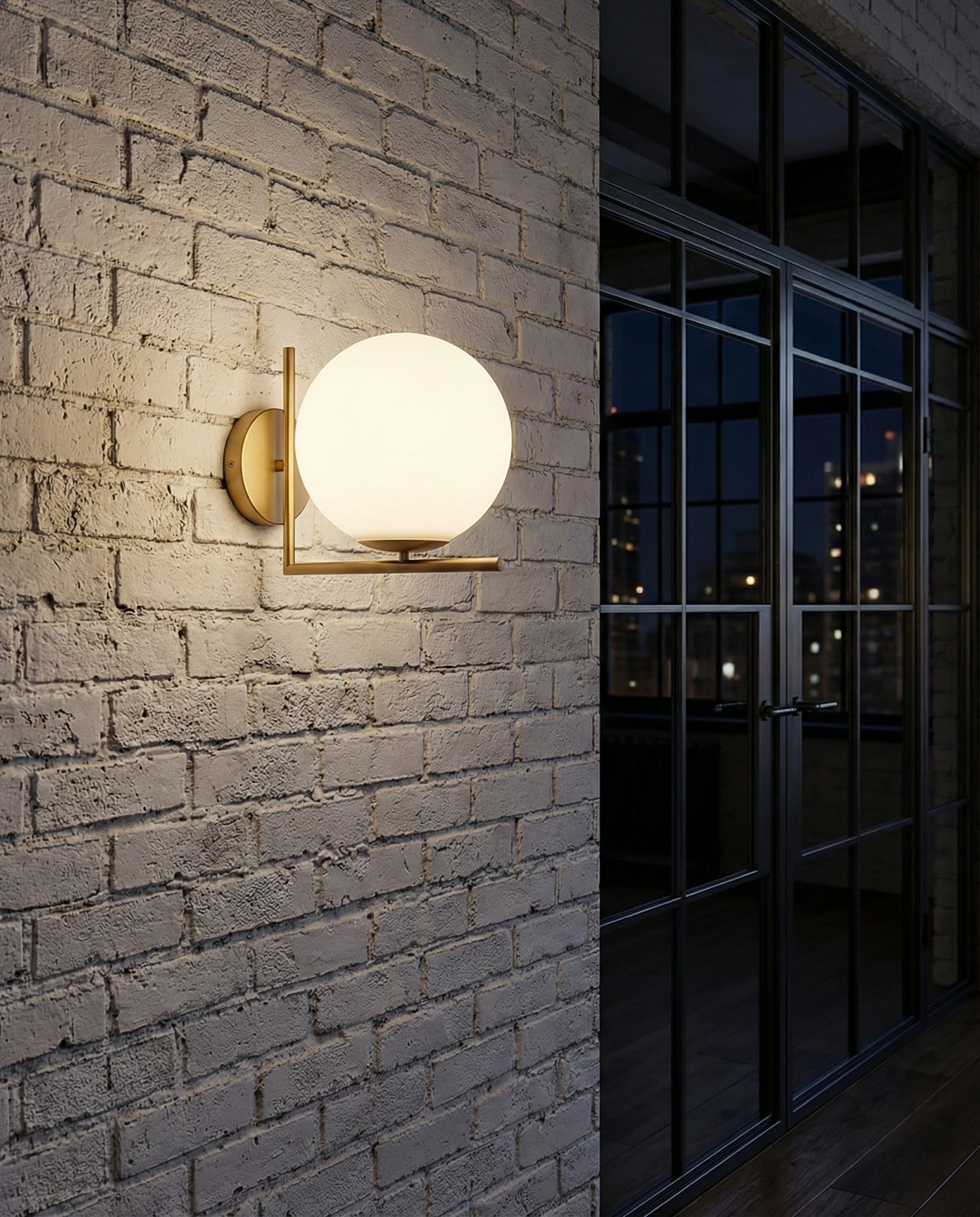 DaraLight globe sconce on a white brick wall, room scene
