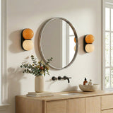 Matteo twin-globe sconces flanking a bathroom mirror — lifestyle