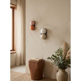 Matteo twin-globe sconces on a warm plaster wall — lifestyle