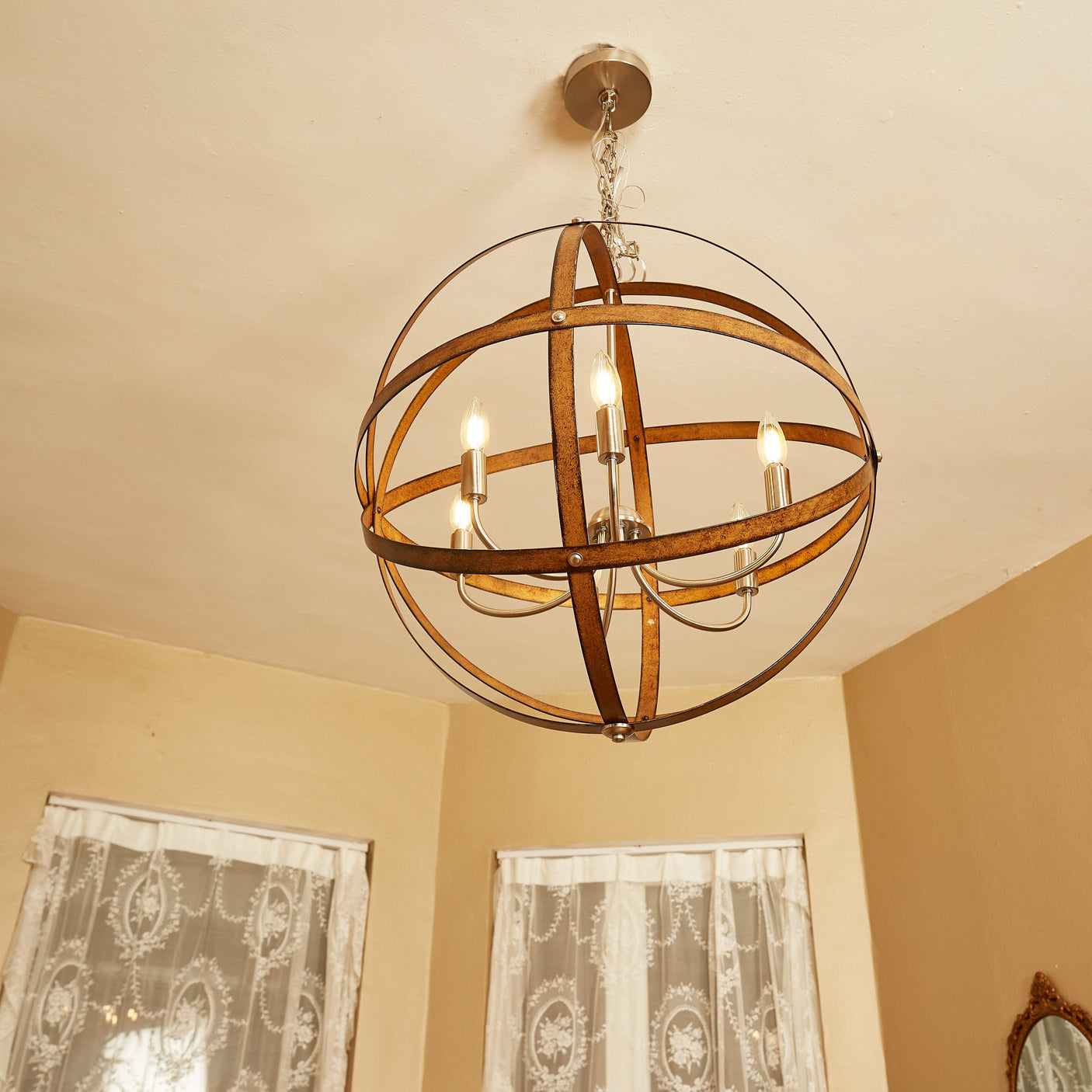 Ines orb pendant glowing in a farmhouse room, room scene