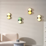 Matteo twin-globe sconces in mixed colours on a living room wall — lifestyle