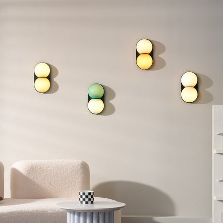 Matteo twin-globe sconces in mixed colours on a living room wall — lifestyle