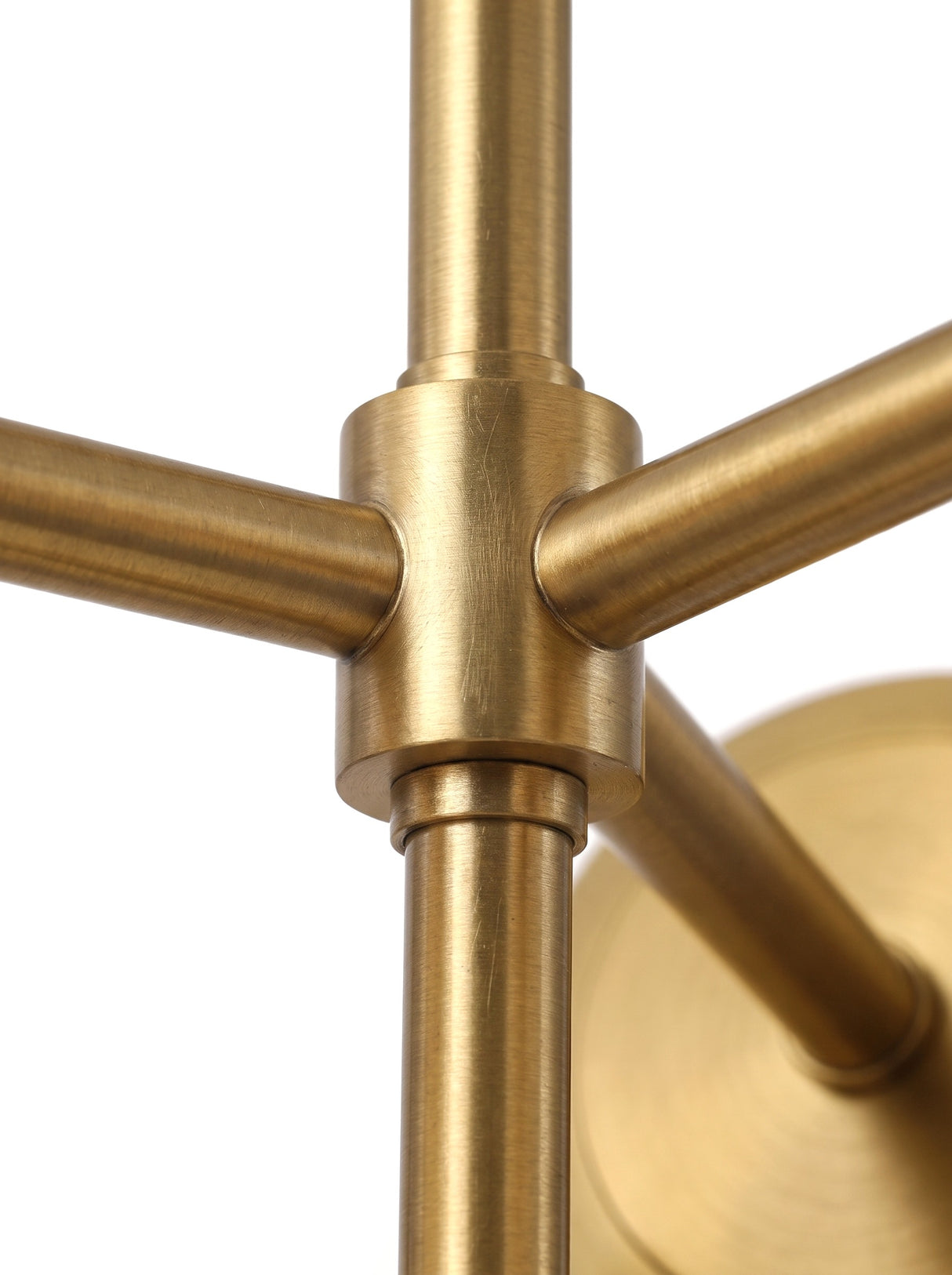 Astra central brass hub and arm joinery, close-up on white