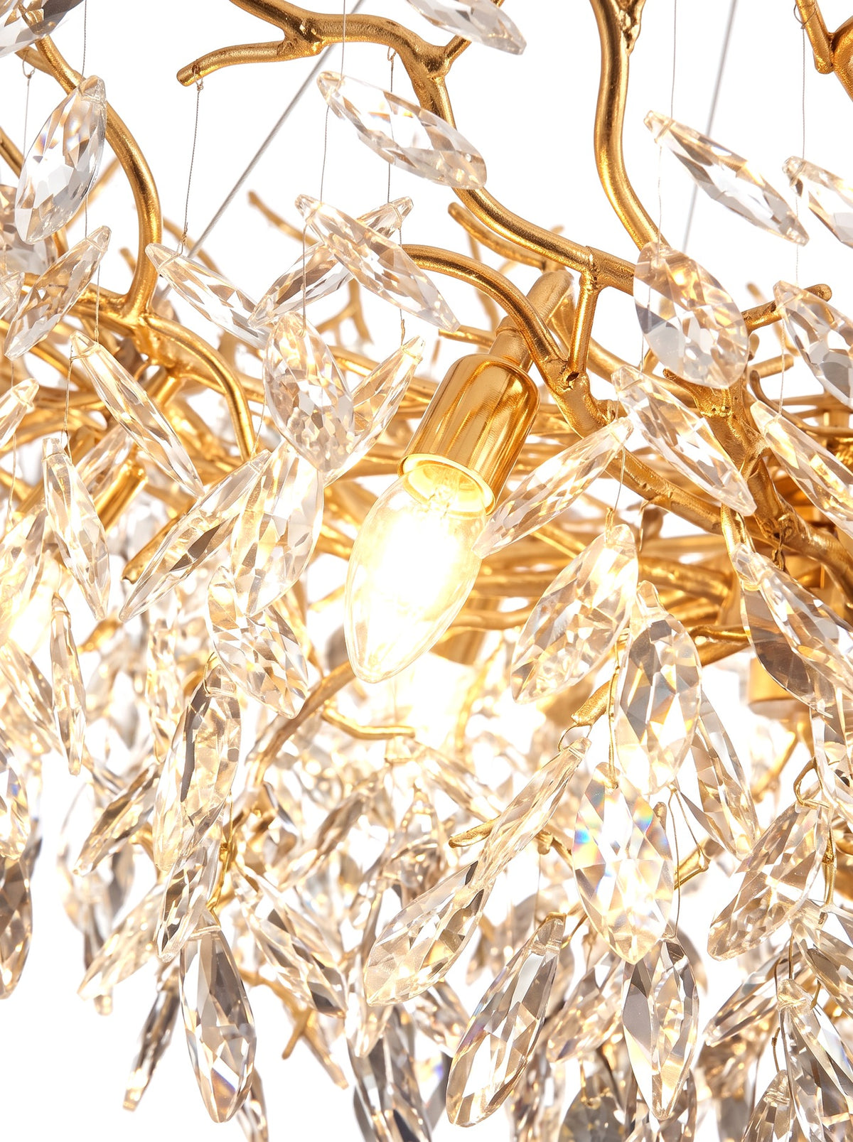 Close-up of a warm candle bulb glowing among the crystals
