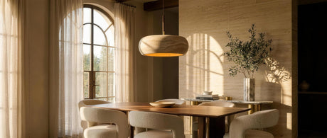 Anello travertine donut pendant over a walnut table in a luxurious travertine dining room — lifestyle