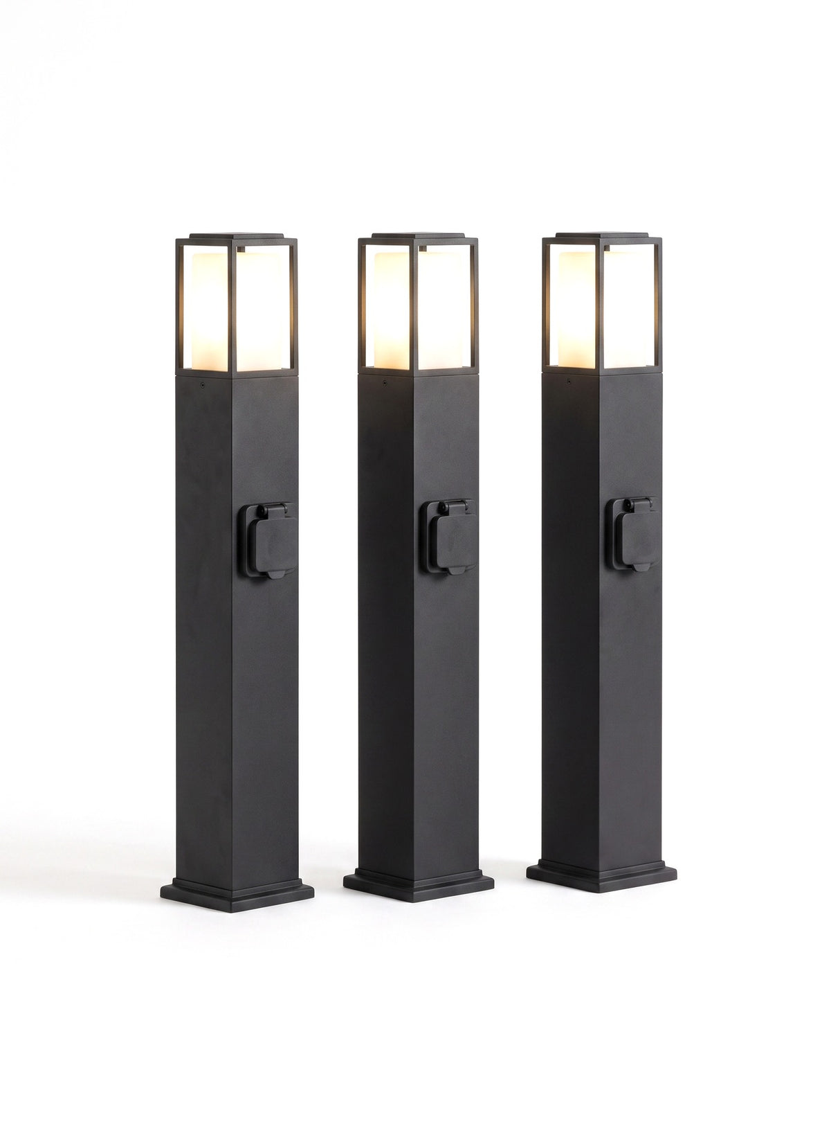 A set of three Cairn bollard path lights on white, heads glowing