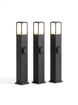 A set of three Cairn bollard path lights on white, heads glowing