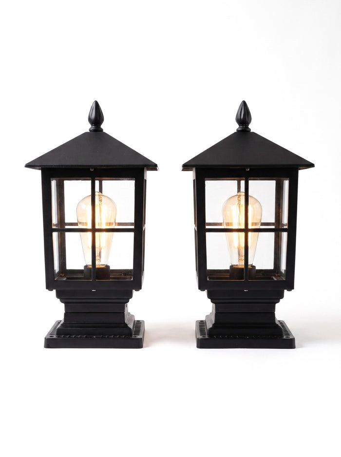 A matched pair of Gable lanterns on white, glowing warm