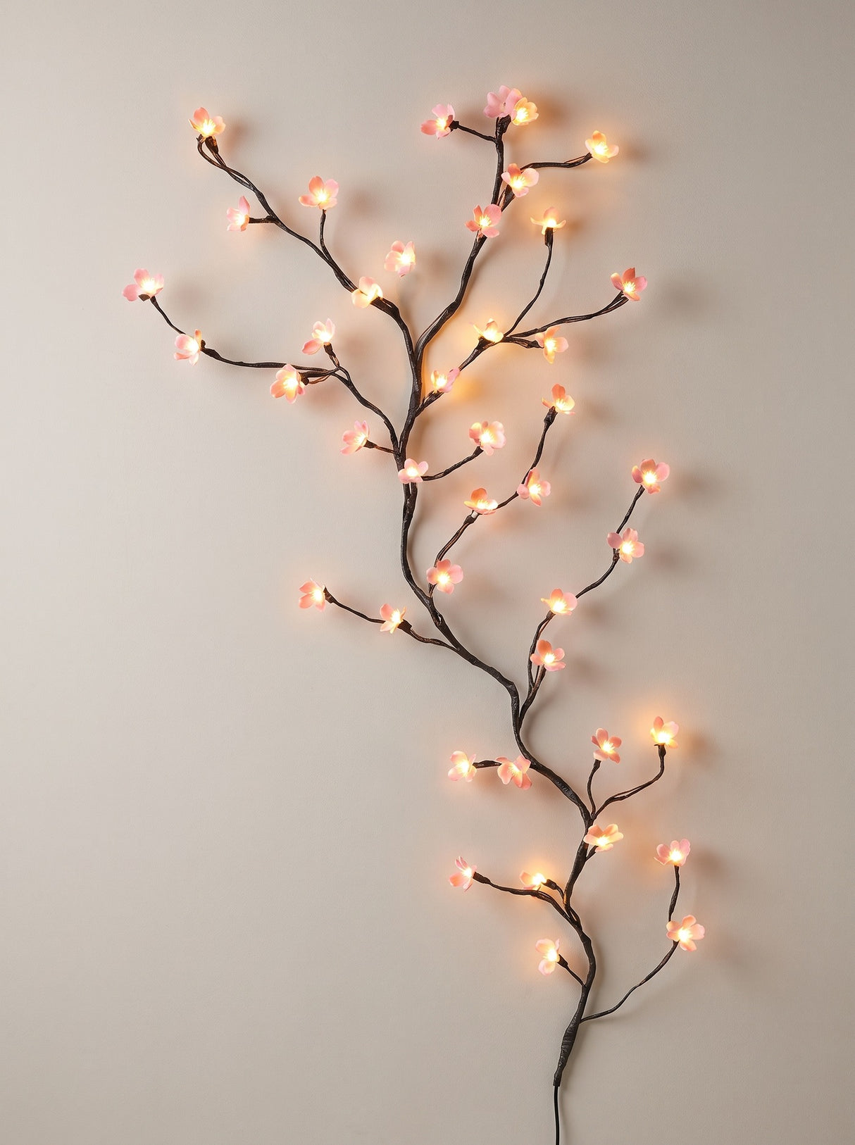 Hana LED blossom branch light arranged on a wall, front view