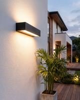 Outdoor LED wall light mounted on house wall at dusk, lifestyle