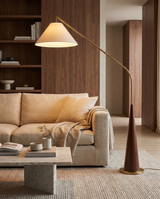 Arc floor lamp with wooden base over sofa, lifestyle