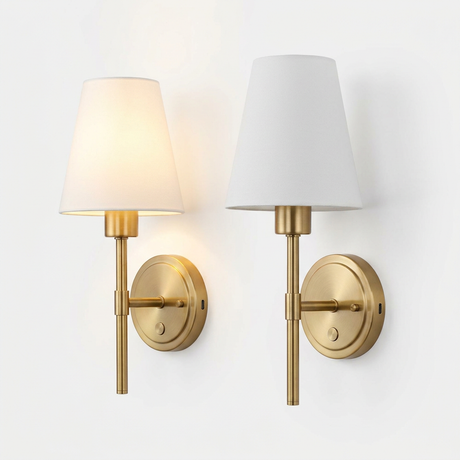 Pair of brass cordless sconces on white studio background