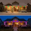 Holiday red and green eave lights on snowy home