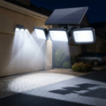 3-head solar security light illuminating a driveway at night
