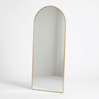 Gold arched floor mirror studio photo on white background