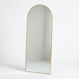 Gold arched floor mirror studio photo on white background