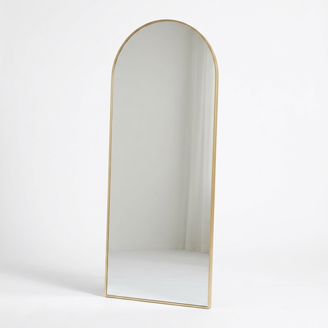 Gold arched floor mirror studio photo on white background