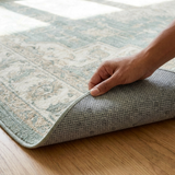 Folded corner of ultra thin non slip washable rug showing the low profile