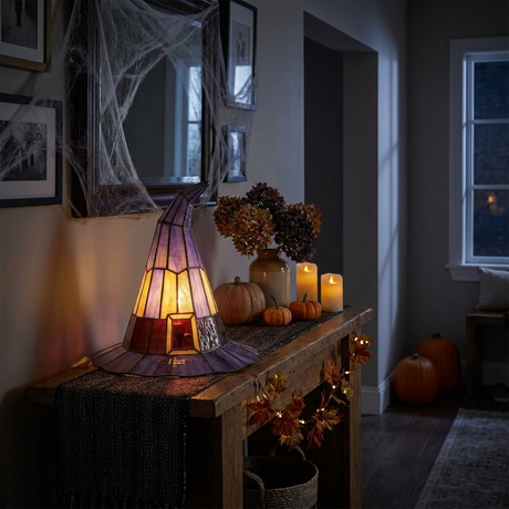 Witch hat lamp as spooky-cozy accent lighting in an entryway at night