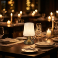 Cordless alabaster mini lamp glowing on a candlelit dinner table