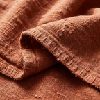 Macro of heavyweight stonewashed linen weave and hem