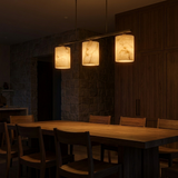 Alabaster chandelier glowing as the only light in a dim dining room