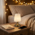 Cordless alabaster lamp on a nightstand beside a book for scale