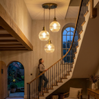 Fluted glass cluster pendant in a two-story stairwell for scale