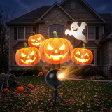 Holiday projector casting Halloween pumpkins and ghost on a house