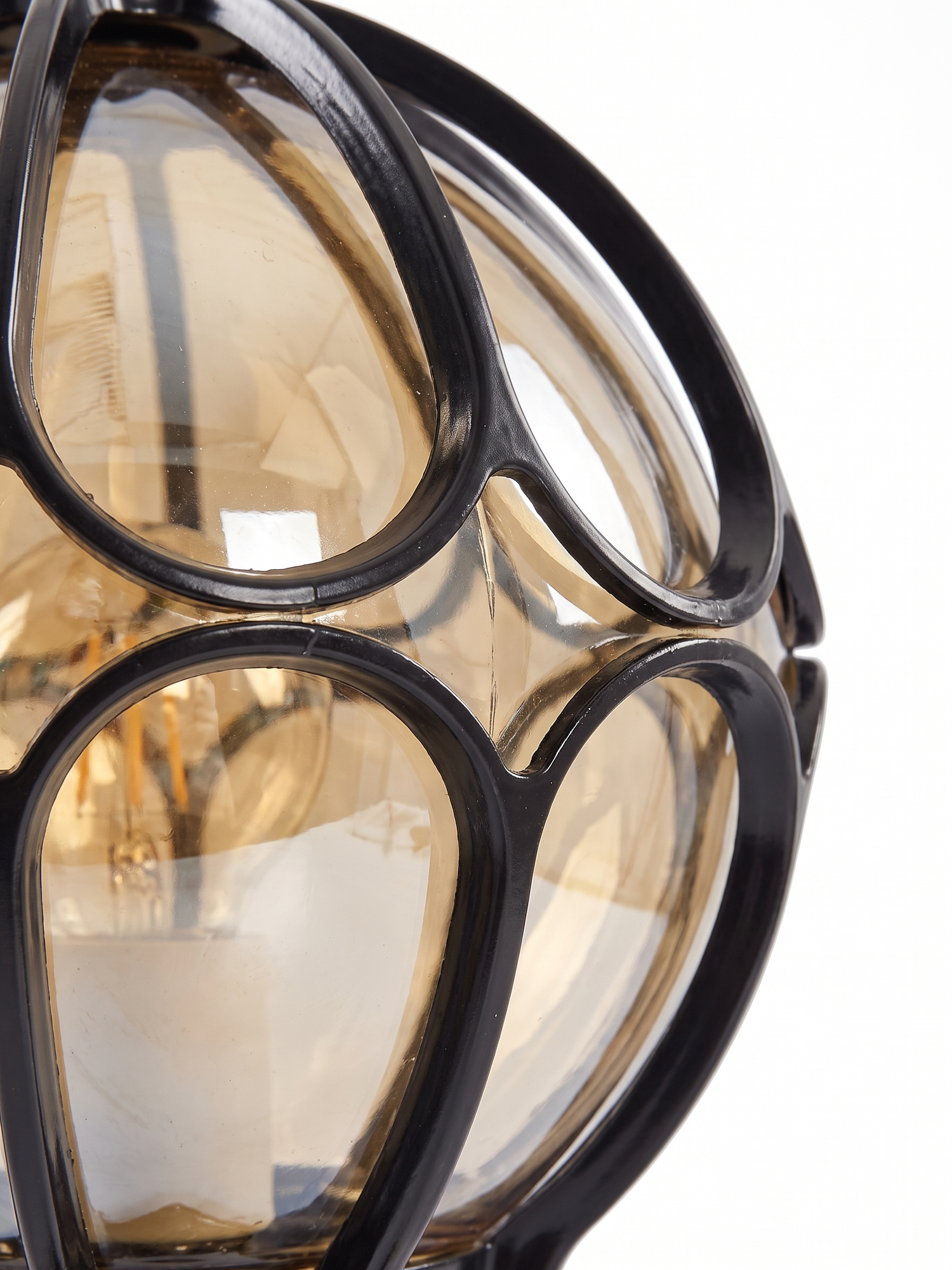 Lune amber glass panels held in the black cast-aluminum cage, close-up on white