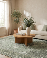Juniper sage vintage medallion rug in a warm modern-organic living room with ceramic vase — lifestyle